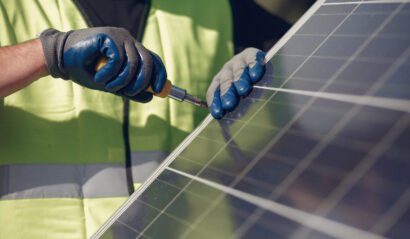 Engineer in a white helmet. Man near solar panel.